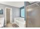 Bathroom with walk-in closet, tub, and shower at 7720 Langwood Dr, Indianapolis, IN 46268