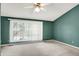 Cozy bedroom with large windows and neutral carpet at 7720 Langwood Dr, Indianapolis, IN 46268