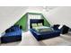 Bright bedroom features natural light, blue accents, a bed and seating at 7720 Langwood Dr, Indianapolis, IN 46268