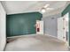 Open bedroom with ceiling fan, and access to a full bathroom at 7720 Langwood Dr, Indianapolis, IN 46268