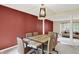 Well-lit dining room featuring a wooden table, fabric chairs, and connections to other living areas at 7720 Langwood Dr, Indianapolis, IN 46268