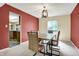 Charming dining room with modern light fixture, wooden table, comfortable chairs, and view to kitchen at 7720 Langwood Dr, Indianapolis, IN 46268