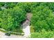 Aerial image of a home with an attached garage and driveway, surrounded by mature trees at 7720 Langwood Dr, Indianapolis, IN 46268