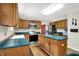 This kitchen features a center island, stainless steel appliances, and wooden cabinets for a classic design at 7720 Langwood Dr, Indianapolis, IN 46268