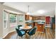View of an open kitchen and a breakfast nook with backyard view; light and bright space at 7720 Langwood Dr, Indianapolis, IN 46268