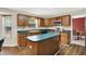 A kitchen featuring wood cabinets, center island, and stainless steel appliances, complemented by an adjacent dining area at 7720 Langwood Dr, Indianapolis, IN 46268