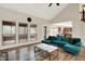 Living room with hardwood floors, a view of the backyard, and an open floor plan to the kitchen and dining area at 7720 Langwood Dr, Indianapolis, IN 46268