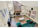 Open living room with vaulted ceilings, brick fireplace, wood floors, and natural light at 7720 Langwood Dr, Indianapolis, IN 46268