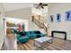 An open-concept living room adjacent to the kitchen, featuring a staircase, and modern decor at 7720 Langwood Dr, Indianapolis, IN 46268