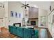 This living room features a vaulted ceiling, exposed brick fireplace, hardwood floors and natural light at 7720 Langwood Dr, Indianapolis, IN 46268