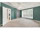Bright main bedroom with natural light, neutral carpet, and a doorway leading to bathroom at 7720 Langwood Dr, Indianapolis, IN 46268