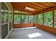 Enclosed sunroom with wood ceilings, and views to backyard trees at 7720 Langwood Dr, Indianapolis, IN 46268