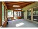 Enclosed sunroom with wood ceilings, and door to the outside at 7720 Langwood Dr, Indianapolis, IN 46268