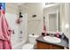 Bright bathroom featuring a shower-tub combo and vanity with sink at 7906 States Bend Ln, Indianapolis, IN 46239