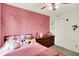 Bright bedroom with pink walls, carpet, and large dresser at 7906 States Bend Ln, Indianapolis, IN 46239
