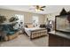 A relaxing bedroom is accentuated by a large chair, great natural light, and a comfortable sleeping space at 7906 States Bend Ln, Indianapolis, IN 46239