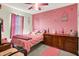 Cozy bedroom with pink walls, pink accents and carpet at 7906 States Bend Ln, Indianapolis, IN 46239