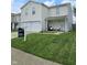 Traditional two-story house featuring a manicured front lawn and welcoming porch, complemented by professional real estate signage at 7906 States Bend Ln, Indianapolis, IN 46239