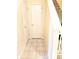 Hallway with stairs, tile floor, and two storage closets at 7906 States Bend Ln, Indianapolis, IN 46239