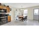 Bright kitchen area boasts stainless steel appliances, a round wooden table with seating, and a rear entrance door at 7906 States Bend Ln, Indianapolis, IN 46239