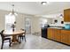 Bright and airy kitchen with dark appliances and cabinetry, complemented by a charming dining area with natural light at 7906 States Bend Ln, Indianapolis, IN 46239