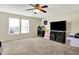 Bright living room featuring neutral walls, plush carpet, and ample natural light from large windows at 7906 States Bend Ln, Indianapolis, IN 46239