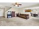 Spacious living room with neutral carpet, open layout, and seamless flow into the adjacent kitchen and dining area at 7906 States Bend Ln, Indianapolis, IN 46239