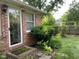 Backyard exterior featuring a brick wall and greenery at 806 S Jefferson St, Brownsburg, IN 46112