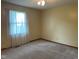 Neutral bedroom with carpeted floor and window allowing natural light at 806 S Jefferson St, Brownsburg, IN 46112
