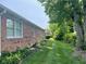 Side exterior view of brick house with green lawn and landscaping at 806 S Jefferson St, Brownsburg, IN 46112