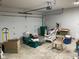 Cluttered garage with white door, storage, and overhead lighting at 806 S Jefferson St, Brownsburg, IN 46112