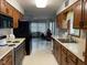 Functional kitchen with wood cabinets and black appliances open to an adjacent dining or living area at 806 S Jefferson St, Brownsburg, IN 46112