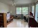 Cozy bonus room with bright lighting, open windows, and direct backyard access through glass doors at 806 S Jefferson St, Brownsburg, IN 46112