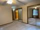 Spacious main bedroom with large mirrored closets, neutral carpet, and a ceiling fan at 806 S Jefferson St, Brownsburg, IN 46112