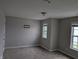 Carpeted bedroom with neutral walls, white trim, and dual windows offering ample natural light at 8415 Fieldfare Way, Indianapolis, IN 46237