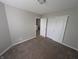 Cozy bedroom with neutral paint, plush carpet, and a closet with sliding doors at 8415 Fieldfare Way, Indianapolis, IN 46237