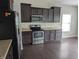 Well-appointed kitchen featuring stainless steel appliances, and dark wood cabinets and hardwood floors at 8415 Fieldfare Way, Indianapolis, IN 46237