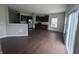 Modern kitchen with dark cabinets, stainless steel appliances, hardwood flooring, and sliding glass doors at 8415 Fieldfare Way, Indianapolis, IN 46237