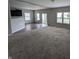 Spacious living room with carpet, hardwood floor, plenty of natural light, and open floor plan at 8415 Fieldfare Way, Indianapolis, IN 46237