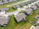 An aerial shot captures a home with a backyard deck and a well-manicured lawn, surrounded by neighboring houses at 8842 Twain Ln, Indianapolis, IN 46239