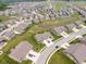 Expansive aerial view of a neighborhood with well-manicured lawns and multiple ponds adding to the community's charm at 8842 Twain Ln, Indianapolis, IN 46239