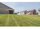 Expansive backyard with green lawn and houses in the background at 8842 Twain Ln, Indianapolis, IN 46239