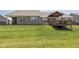 Well-maintained backyard with green grass, a deck, and a covered patio for outdoor enjoyment at 8842 Twain Ln, Indianapolis, IN 46239
