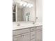 Bathroom with double sinks, gray shower, and white cabinetry at 8842 Twain Ln, Indianapolis, IN 46239
