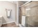 Bathroom featuring a gray-tiled shower with glass door and a white sink at 8842 Twain Ln, Indianapolis, IN 46239