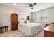 This bedroom has two wardrobes, a ceiling fan, and a bed with white comforter at 8842 Twain Ln, Indianapolis, IN 46239