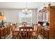 This dining room has a wood table and chairs, chandelier, and a large wooden cabinet at 8842 Twain Ln, Indianapolis, IN 46239