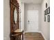 Elegant foyer with hardwood floors, decorative furnishings, and a classic coat rack at 8842 Twain Ln, Indianapolis, IN 46239