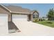 Beautiful home featuring a two-car garage, manicured landscaping, and a spacious driveway at 8842 Twain Ln, Indianapolis, IN 46239