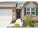 Inviting home with a brick facade, lush landscaping, black shutters, and a two-car garage at 8842 Twain Ln, Indianapolis, IN 46239